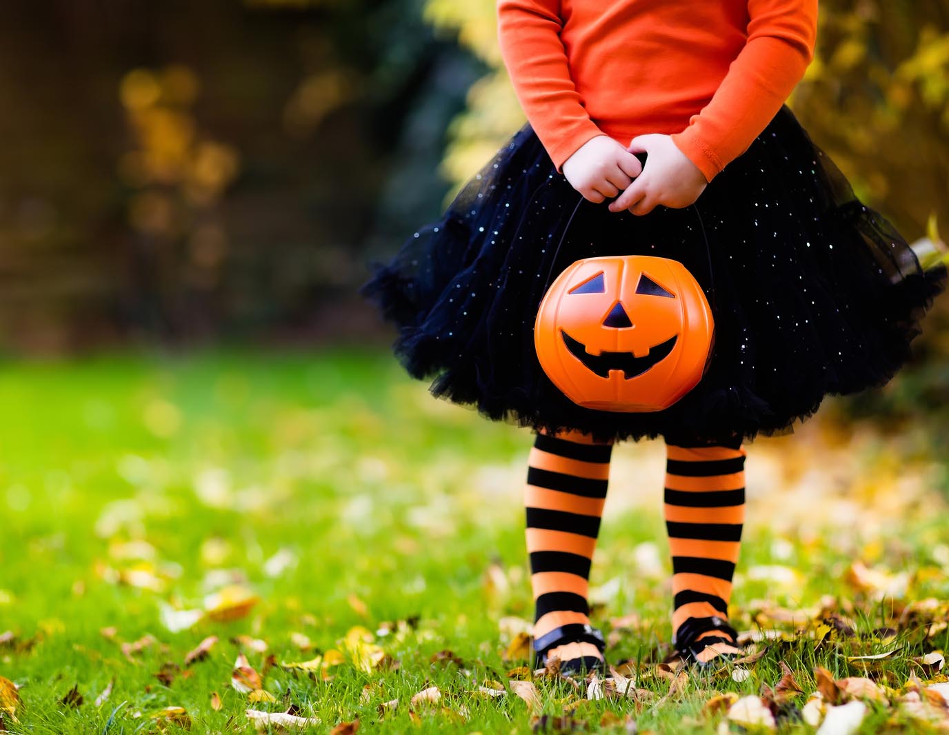 image of girl holding a trick-or-treating bucket